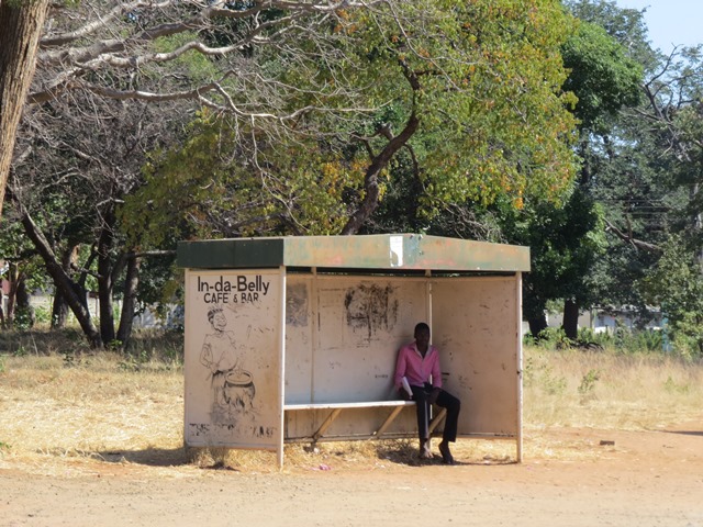 Man waiting for a bus, Victoria Falls, Zimbabwe, May 2016
