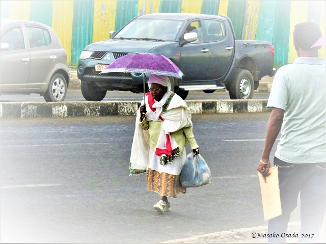 Old lady walking in the middle of the road