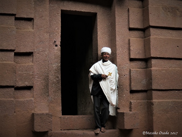 Priest standing at the entrance