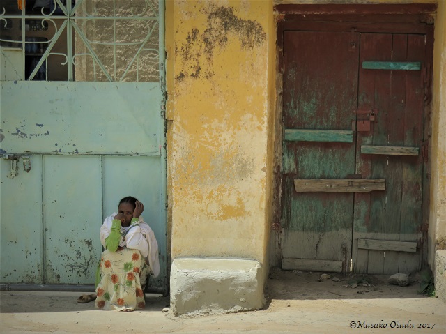 Woman sitting in shade