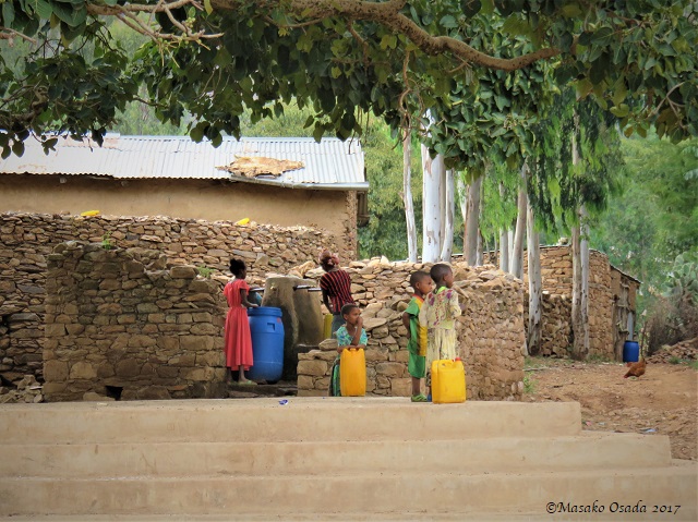 Children drawing water