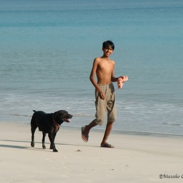 A boy and a dog, Andaman Islands, India 2010