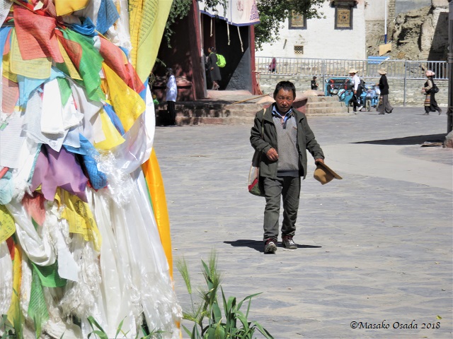 Short man walking. Palcho Monastery, Gyangtse, Tibet, September 2018
