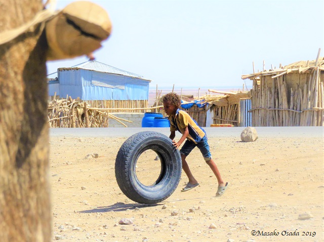 Boy playing with tyre, Hamedela village near Dallol, Ethiopia, January 2019109116