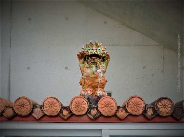 Shiisaa on top of municipal notice board, Naha, Okinawa, November 2019